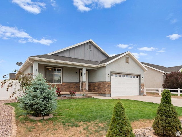 517 E 1140 S, Roosevelt, UT 84066 - view of front of house featuring stone siding, a garage, covered porch, concrete driveway, and board and batten siding