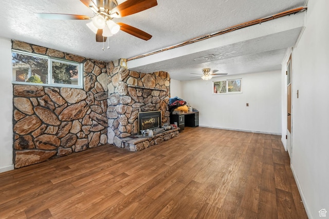 1901 W Kirkham Way S, Taylorsville, UT 84129 - living area with a ceiling fan, a textured ceiling, wood finished floors, and a stone fireplace