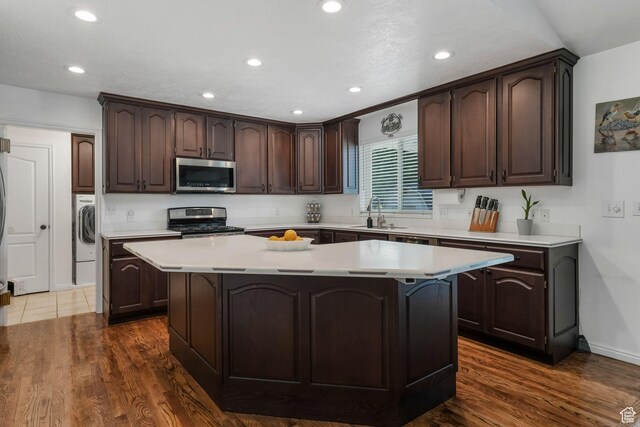 5077 W 11000 N, Highland, UT 84003 - kitchen featuring appliances with stainless steel finishes, dark brown cabinets, a center island, light countertops, and recessed lighting