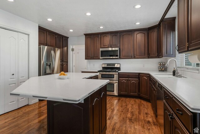 5077 W 11000 N, Highland, UT 84003 - kitchen featuring stainless steel appliances, a center island, dark brown cabinets, light countertops, and recessed lighting