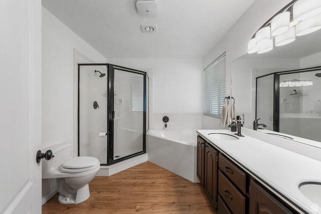5077 W 11000 N, Highland, UT 84003 - full bathroom featuring a stall shower, a garden tub, double vanity, and wood finished floors