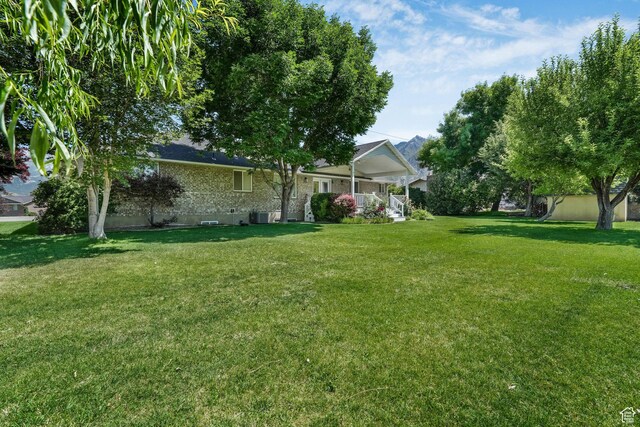 5077 W 11000 N, Highland, UT 84003 - view of grassy yard with covered porch