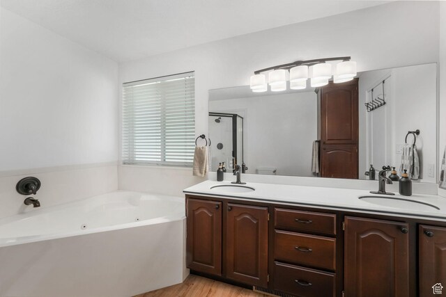 5077 W 11000 N, Highland, UT 84003 - bathroom with double vanity, a tub with jets, a shower stall, and wood finished floors