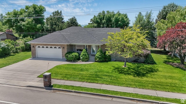 5077 W 11000 N, Highland, UT 84003 - ranch-style house featuring an attached garage, concrete driveway, brick siding, and a front lawn