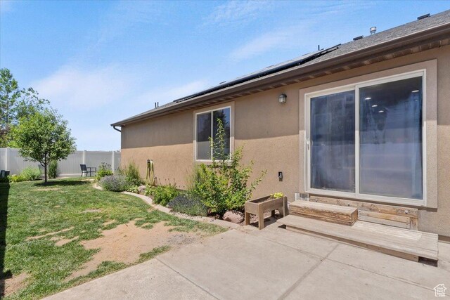 1025 N Apple Seed Ln, Santaquin, UT 84655 - view of side of home with a patio area, stucco siding, solar panels, and entry steps