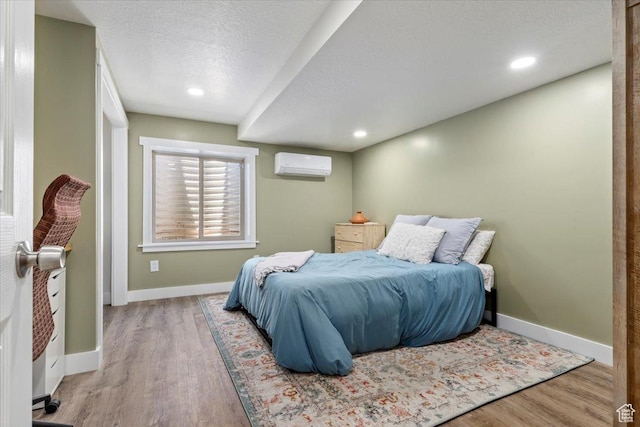 1025 N Apple Seed Ln, Santaquin, UT 84655 - bedroom with wood finished floors, a wall mounted air conditioner, a textured ceiling, and recessed lighting