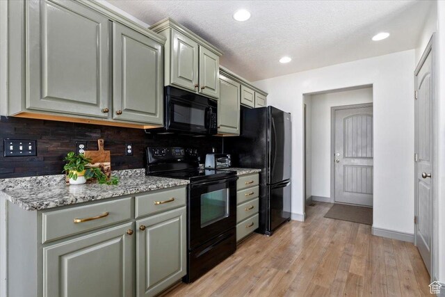 1025 N Apple Seed Ln, Santaquin, UT 84655 - kitchen with black appliances, gray cabinetry, tasteful backsplash, light wood-type flooring, and light stone countertops