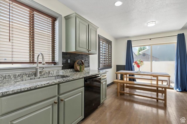1025 N Apple Seed Ln, Santaquin, UT 84655 - kitchen featuring dishwasher, a textured ceiling, light wood-style flooring, light stone countertops, and green cabinets