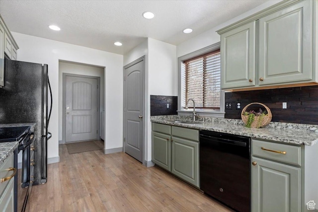 1025 N Apple Seed Ln, Santaquin, UT 84655 - kitchen with black appliances, light wood-type flooring, light stone counters, and recessed lighting