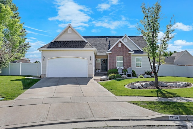 1303 S 1650 W, Syracuse, UT 84075 - traditional home featuring a garage, driveway, and a shingled roof