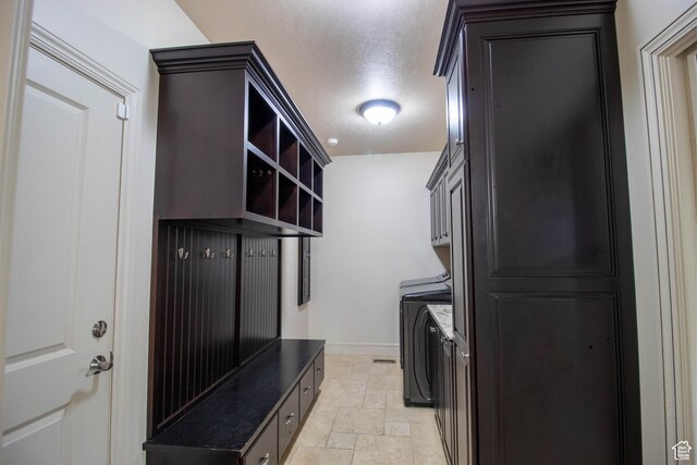 5818 N Cambridge Dr E, Mountain Green, UT 84050 - laundry room featuring stone finish floors, cabinet space, and washer / dryer