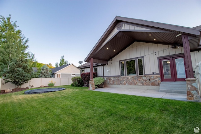 5818 N Cambridge Dr E, Mountain Green, UT 84050 - rear view of house featuring entry steps, a patio area, and stone siding