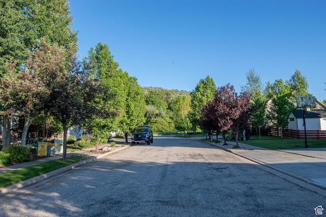 5818 N Cambridge Dr E, Mountain Green, UT 84050 - view of asphalt street with curbs and sidewalks