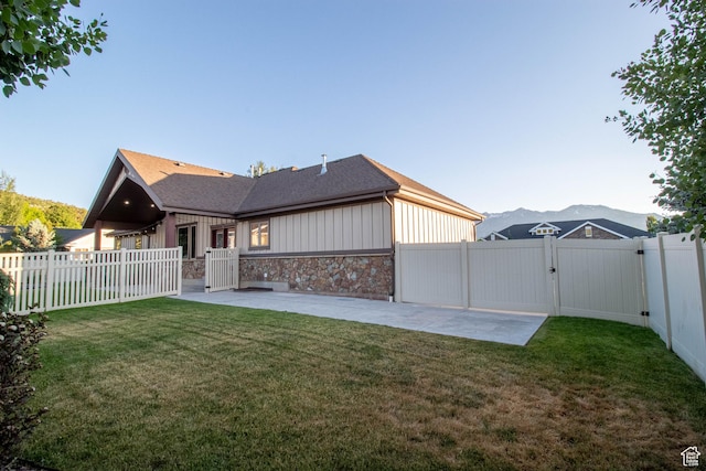 5818 N Cambridge Dr E, Mountain Green, UT 84050 - rear view of property with a gate, a patio, stone siding, and a fenced backyard
