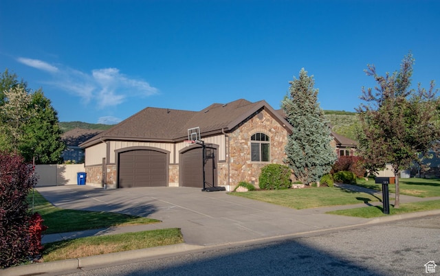 5818 N Cambridge Dr E, Mountain Green, UT 84050 - french country home featuring a garage, stone siding, concrete driveway, and a shingled roof