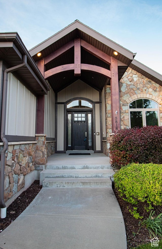 5818 N Cambridge Dr E, Mountain Green, UT 84050 - doorway to property with stone siding and board and batten siding