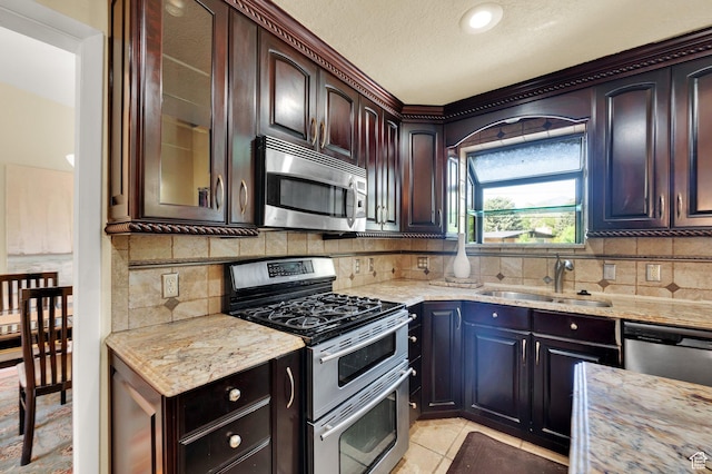 1623 E Spring Run Dr, Holladay, UT 84117 - kitchen with appliances with stainless steel finishes, light stone countertops, tasteful backsplash, glass insert cabinets, and dark brown cabinetry