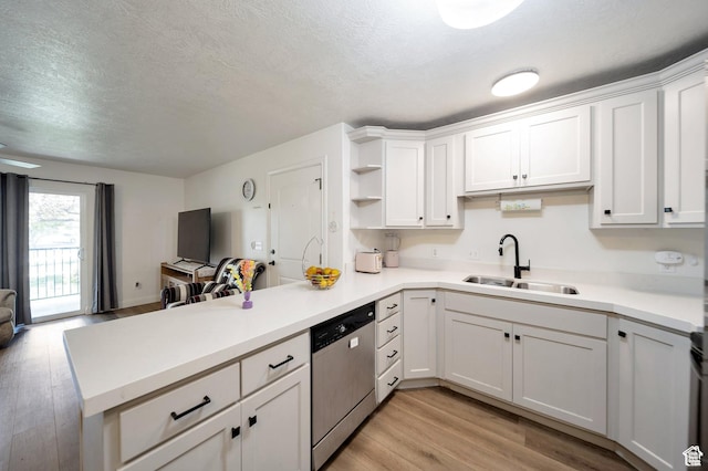 317 S 1000 W Unit 204, Pleasant Grove, UT 84062 - kitchen featuring stainless steel dishwasher, a peninsula, light wood-type flooring, open floor plan, and white cabinetry