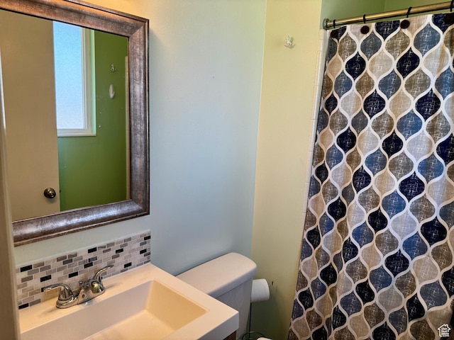 7026 S Wood Green Rd, West Jordan, UT 84084 - bathroom featuring decorative backsplash, curtained shower, and vanity