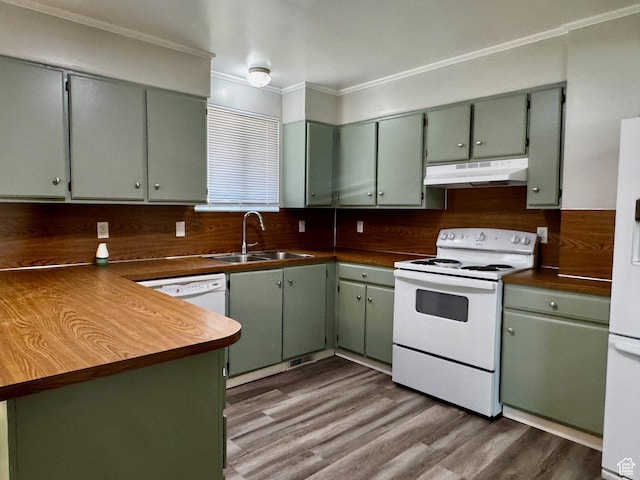 7026 S Wood Green Rd, West Jordan, UT 84084 - kitchen with white appliances, under cabinet range hood, dark countertops, ornamental molding, and a peninsula