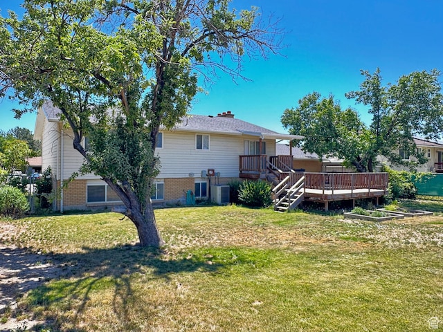 7026 S Wood Green Rd, West Jordan, UT 84084 - rear view of property with a deck, a yard, brick siding, and a chimney
