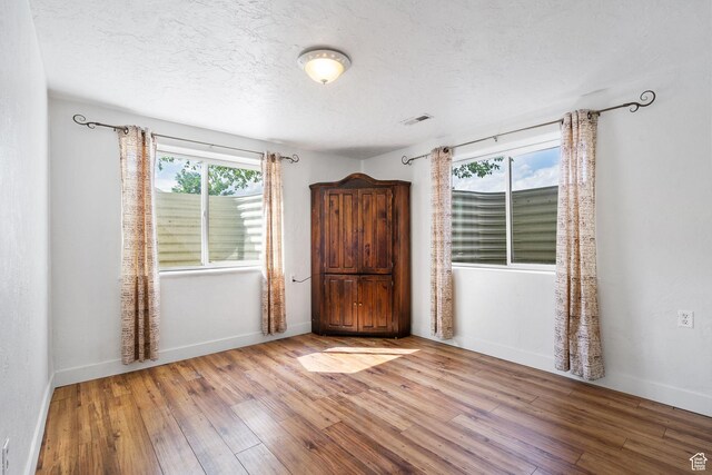 4212 N Majors St E, Eagle Mountain, UT 84005 - unfurnished room featuring wood-type flooring and a textured ceiling