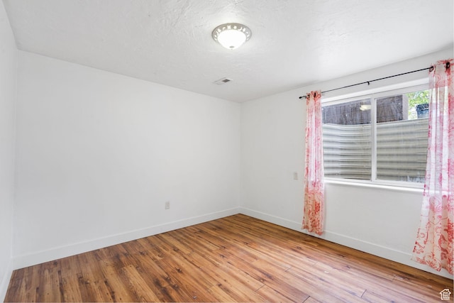 4212 N Majors St E, Eagle Mountain, UT 84005 - unfurnished room with wood-type flooring and a textured ceiling