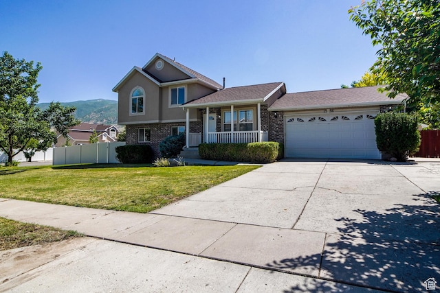1536 N 150 W, Bountiful, UT 84010 - tri-level home with a garage, brick siding, driveway, a porch, and a mountain view