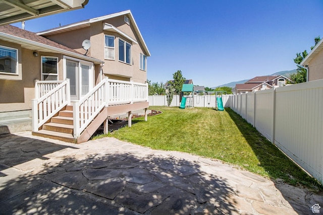 1536 N 150 W, Bountiful, UT 84010 - fenced backyard with a playground and a patio area