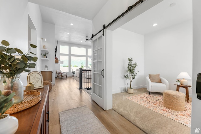 10243 S Dial Ct, South Jordan, UT 84009 - hall featuring a barn door, wood finished floors, and recessed lighting