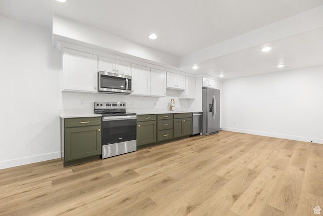 10243 S Dial Ct, South Jordan, UT 84009 - kitchen with appliances with stainless steel finishes, recessed lighting, light countertops, white cabinetry, and green cabinets