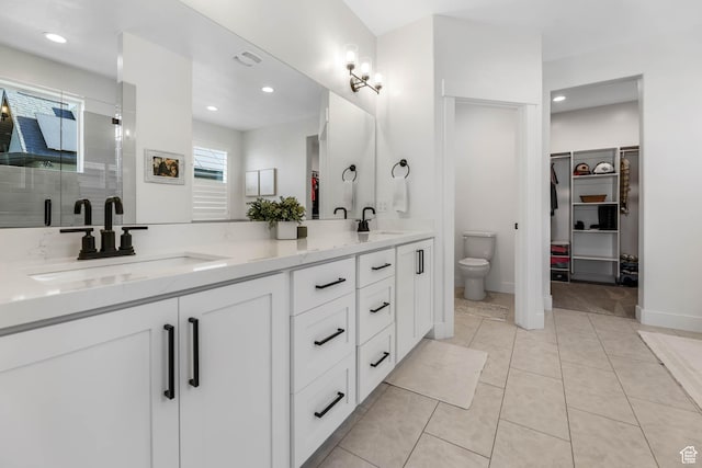 10243 S Dial Ct, South Jordan, UT 84009 - full bathroom with double vanity, a walk in closet, a stall shower, tile patterned floors, and recessed lighting