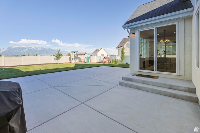10243 S Dial Ct, South Jordan, UT 84009 - view of patio featuring a playground, entry steps, a mountain view, and grilling area