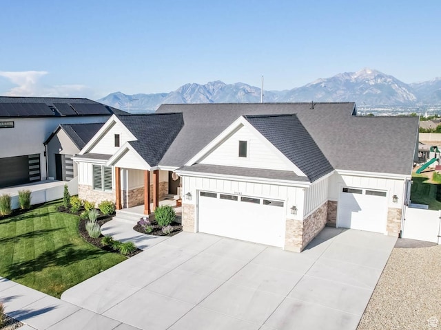 10243 S Dial Ct, South Jordan, UT 84009 - modern farmhouse style home with board and batten siding, stone siding, concrete driveway, a shingled roof, and a mountain view