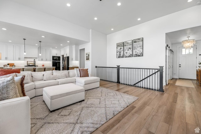 10243 S Dial Ct, South Jordan, UT 84009 - living room with light wood-style floors, recessed lighting, and a chandelier