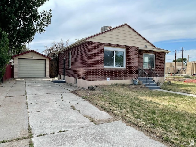 1783 N 300 W, Sunset, UT 84015 - view of property exterior with an outdoor structure, brick siding, a garage, a yard, and driveway