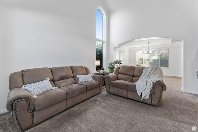10314 S 3970 W, South Jordan, UT 84009 - carpeted living room with a chandelier, a high ceiling, and arched walkways