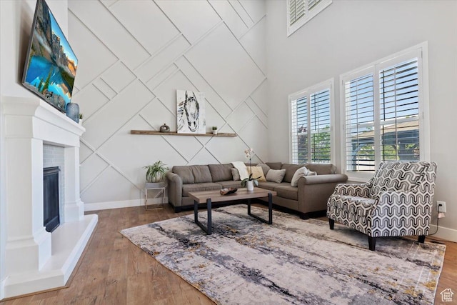 12140 S Galena Grove Way W, Draper, UT 84020 - living room with wood finished floors, a glass covered fireplace, and a decorative wall