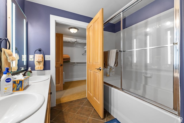 6785 N 2200 W Unit 207, Park City, UT 84098 - bathroom with bath / shower combo with glass door, double vanity, tile patterned flooring, and a walk in closet