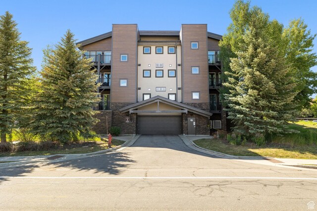 6785 N 2200 W Unit 207, Park City, UT 84098 - view of property featuring a garage and concrete driveway