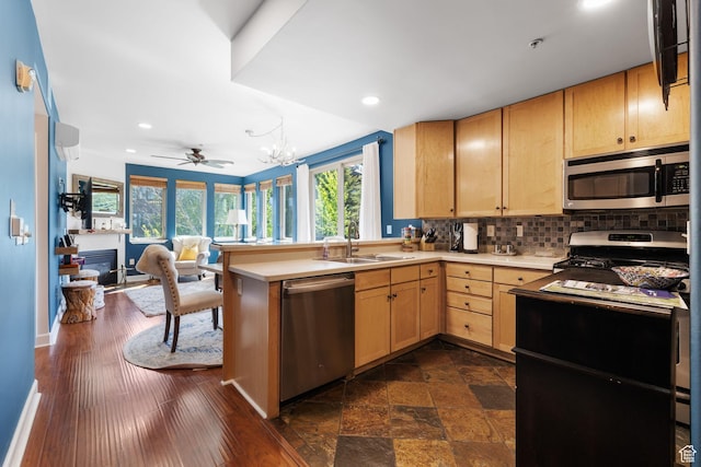 6785 N 2200 W Unit 207, Park City, UT 84098 - kitchen featuring stainless steel appliances, light brown cabinets, tasteful backsplash, a peninsula, and open floor plan
