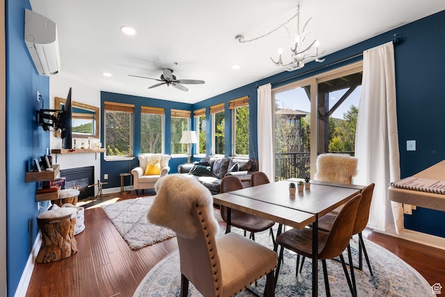 6785 N 2200 W Unit 207, Park City, UT 84098 - dining space featuring a wall unit AC, healthy amount of natural light, a glass covered fireplace, recessed lighting, and wood finished floors
