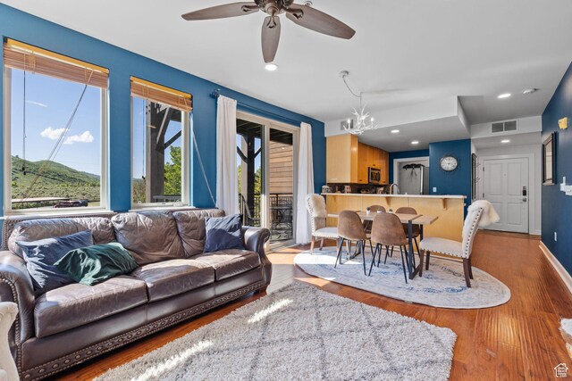6785 N 2200 W Unit 207, Park City, UT 84098 - living area with wood finished floors, a ceiling fan, a chandelier, and recessed lighting