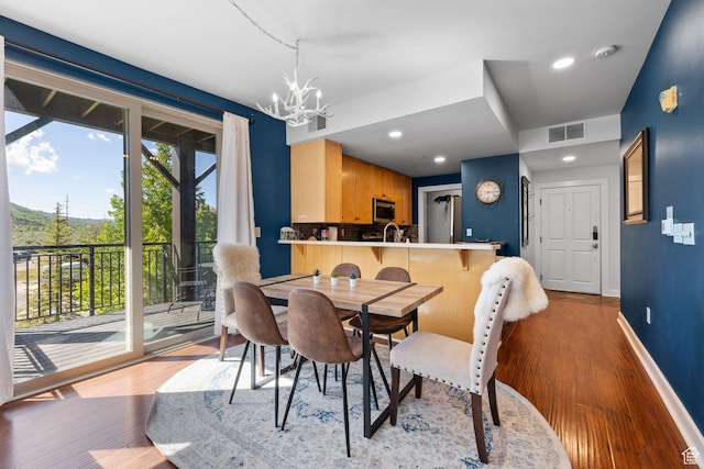 6785 N 2200 W Unit 207, Park City, UT 84098 - dining room with wood finished floors, a chandelier, and recessed lighting