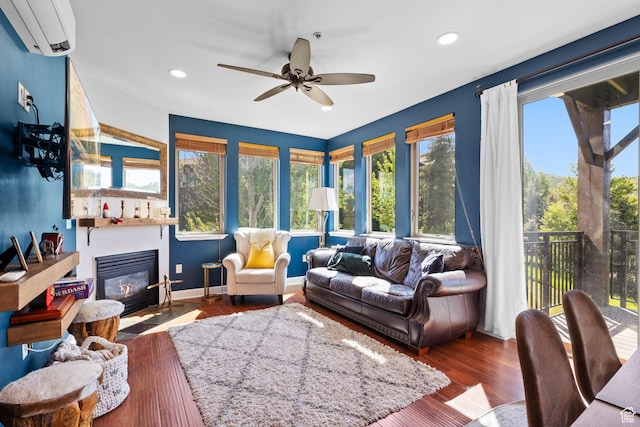 6785 N 2200 W Unit 207, Park City, UT 84098 - living area with an AC wall unit, a fireplace with flush hearth, a ceiling fan, recessed lighting, and wood finished floors