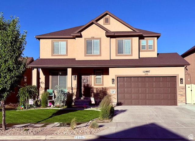 12887 S Wild Mare Way, Riverton, UT 84096 - view of front of property featuring driveway, stucco siding, a front lawn, and a garage