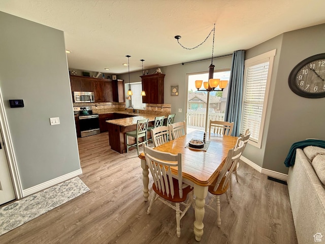 12887 S Wild Mare Way, Riverton, UT 84096 - dining room with light wood-type flooring, recessed lighting, and a chandelier