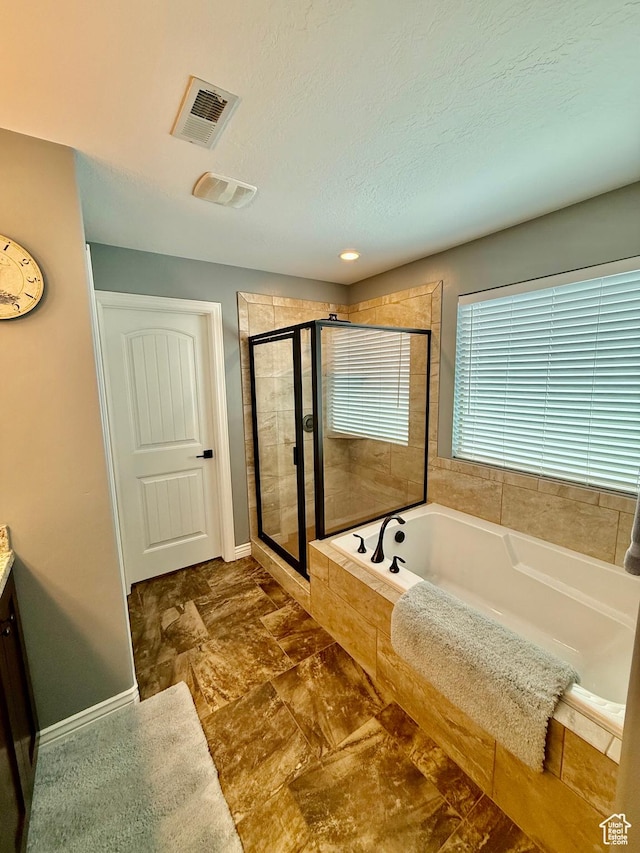 12887 S Wild Mare Way, Riverton, UT 84096 - full bathroom featuring a bath, a stall shower, vanity, and a textured ceiling