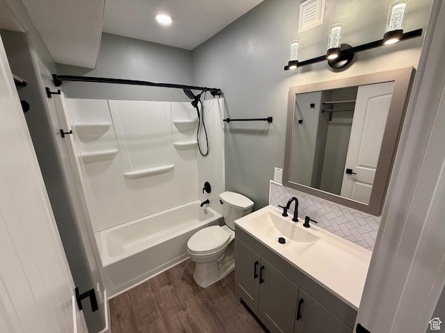 12887 S Wild Mare Way, Riverton, UT 84096 - bathroom featuring wood finished floors, tasteful backsplash, vanity, and washtub / shower combination