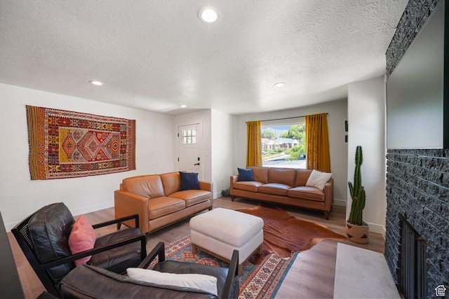 2500 E Simpson Ave S, Salt Lake City, UT 84109 - living area with a textured ceiling, wood finished floors, a fireplace with flush hearth, and recessed lighting